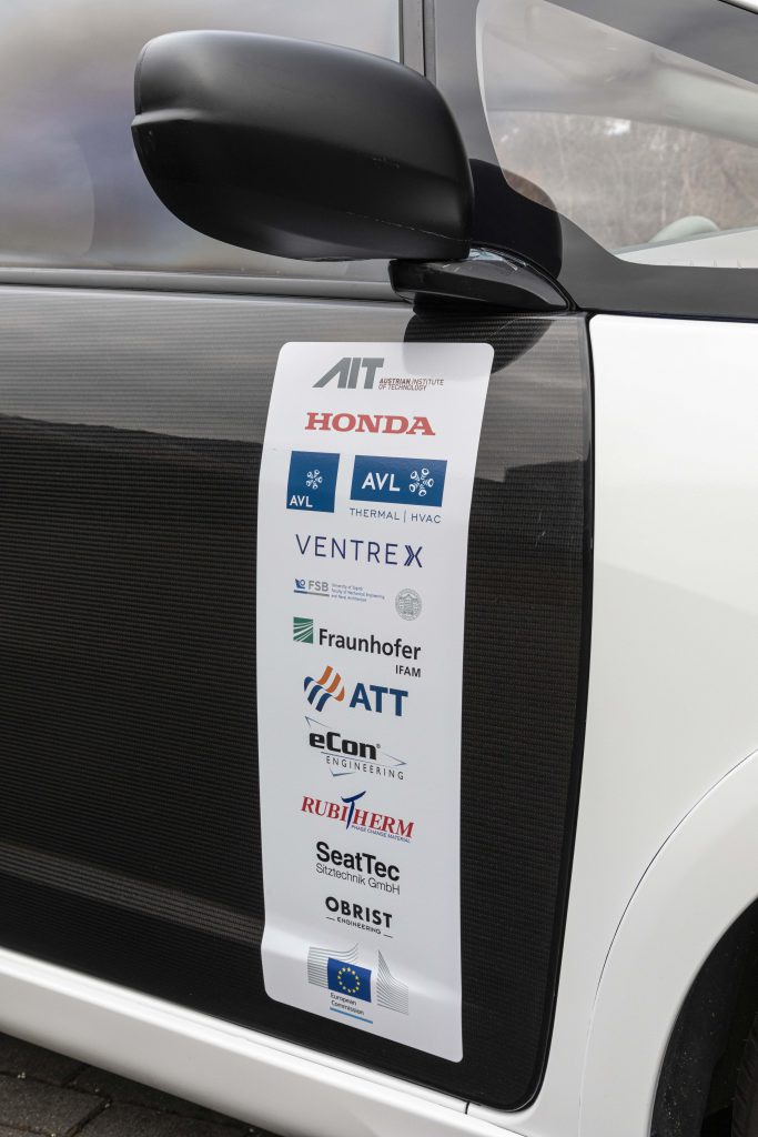 Ensemble of QUIET partner logos on car decoration.